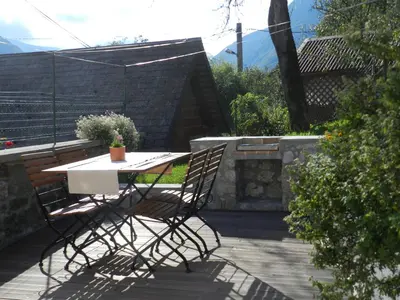 a table and chairs sitting on a patio at Apartments Dvor in Bovec
