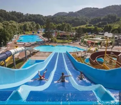 a water park with people riding down a water slide at Apartments Domačija Mlaker in Podčetrtek