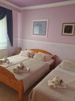 a bedroom with two beds with slippers on them at Rooms Beros in Maribor