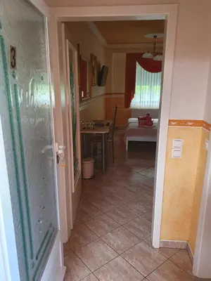 a hallway leading to a kitchen and a dining room at Rooms Beros in Maribor