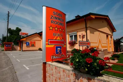 a sign for a store in front of a building at Rooms Beros in Maribor