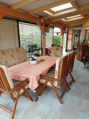 a wooden table and chairs on a patio at Rooms Beros in Maribor