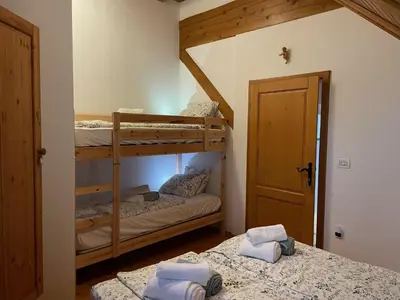 two bunk beds in a room with a door at Apartment Milly in Bled