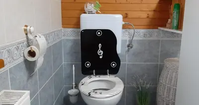 a toilet in a bathroom with a sign on it at Apartment Milly in Bled