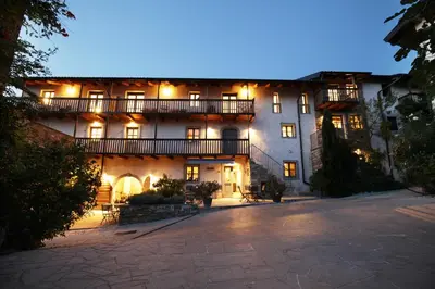 an exterior view of a large building at night at Boutique Hotel Dvor in Dobrovo