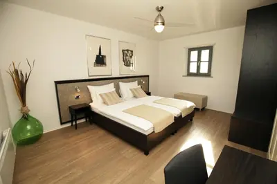 a bedroom with a large bed and a table at Boutique Hotel Dvor in Dobrovo
