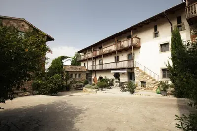 a large building with a courtyard in front of it at Boutique Hotel Dvor in Dobrovo