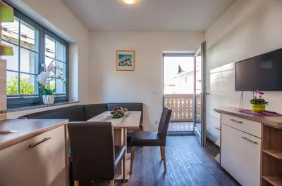 a kitchen and dining room with a table and chairs at Apartments Francka in Bohinj