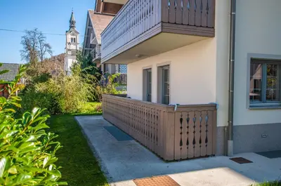a porch of a house with a wooden fence at Apartments Francka in Bohinj