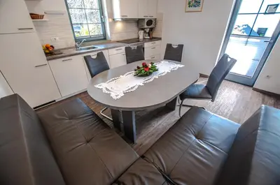 a kitchen with a table and chairs in a room at Apartments Francka in Bohinj