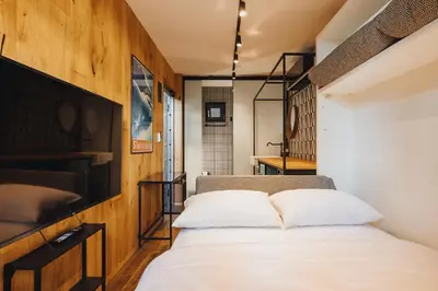 a bedroom with a bed and a tv at City Glamping by ONE66 Hotel in Ljubljana