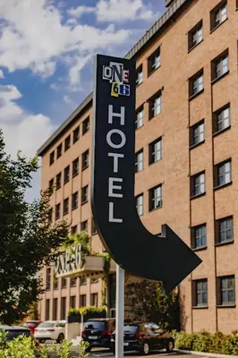 a one hotel sign in front of a building at City Glamping by ONE66 Hotel in Ljubljana
