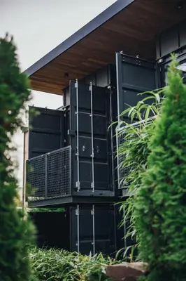 a house with black doors and a balcony at City Glamping by ONE66 Hotel in Ljubljana