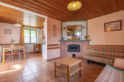 a living room with a couch and a fireplace at Lukčeva domačija počitniška hiša - Happy Rentals in Kostel