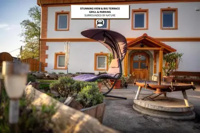 a backyard of a house with a gazebo at Stara sončna hiša in Radovljica