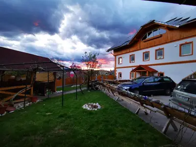 a house with a yard with a car parked next to it at Stara sončna hiša in Radovljica