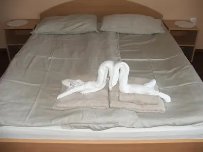a bed with towels and towels on it at Guesthouse Živko in Dobrovce
