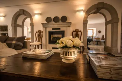 a living room with a vase of flowers on a table at SAUNU DVOR in Tolminski Lom