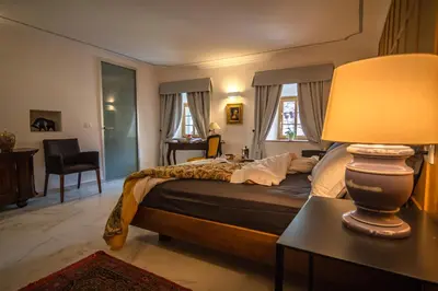 a bedroom with a bed and a lamp on a table at SAUNU DVOR in Tolminski Lom