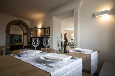 a table with two wine glasses and a table cloth at SAUNU DVOR in Tolminski Lom