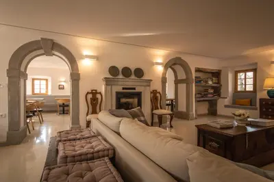 a living room with a couch and a fireplace at SAUNU DVOR in Tolminski Lom