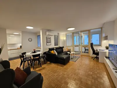 a living room with a couch and a table at Ljubljana Central Suite Martin in the City Center in Ljubljana