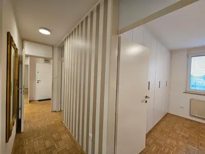 an empty hallway with white walls and wood floors at Ljubljana Central Suite Martin in the City Center in Ljubljana