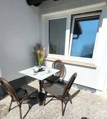a table and chairs on a patio with a window at Lucky center Ljubljana in Ljubljana