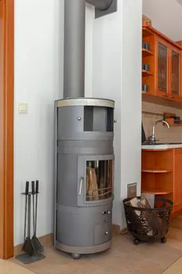 a stove in the corner of a kitchen at Guest House Štruc in Slovenj Gradec