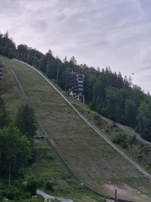 a train track on the side of a hill at Apartment PETRA Mojstrana in Mojstrana