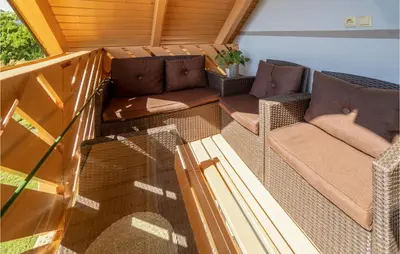 a balcony with wicker chairs and a couch at Stunning Home In Velika Nedelja in Velika Nedelja