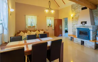 a living room with a table and a fireplace at Stunning Home In Velika Nedelja in Velika Nedelja