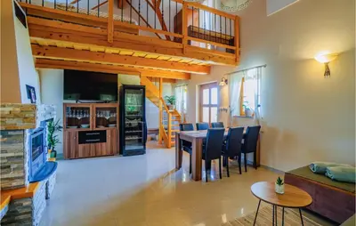 a living room with a table and a dining room at Stunning Home In Velika Nedelja in Velika Nedelja