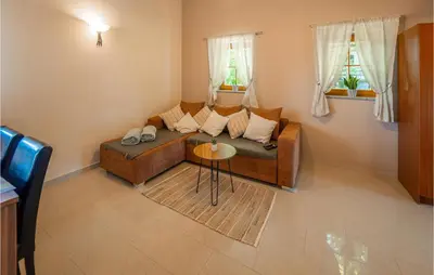 a living room with a couch and a table at Stunning Home In Velika Nedelja in Velika Nedelja