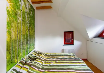 a bedroom with a bed and a large window at Apartments Bohinjskih 7 in Bohinj