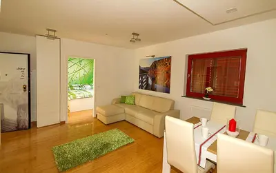 a living room with a couch and a table at Apartments Bohinjskih 7 in Bohinj