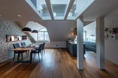 a dining room and kitchen with a table and chairs at Authentic City Stay in Ljubljana