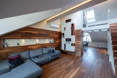 a living room with a couch and a staircase at Authentic City Stay in Ljubljana