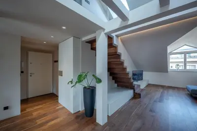 a staircase in a house with a plant in a vase at Authentic City Stay in Ljubljana