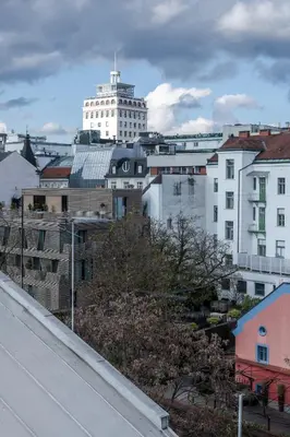 a city with a tall white building in the background at Authentic City Stay in Ljubljana