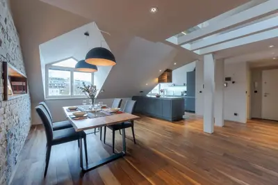 a dining room and kitchen with a table and chairs at Authentic City Stay in Ljubljana