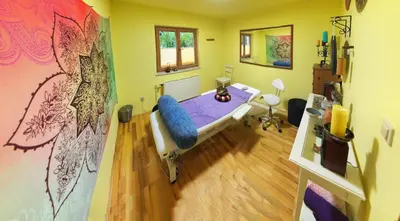 a bedroom with a bed in a room with a painting at Guest House Bitter in Braslovče