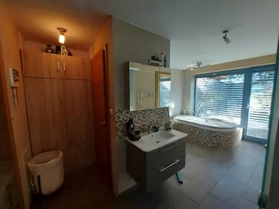 a bathroom with a sink and a bath tub at Guest House Bitter in Braslovče
