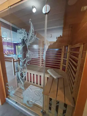 a glass room with a chair and a staircase at Guest House Bitter in Braslovče