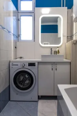 a bathroom with a washing machine and a sink at Cozy apartment in heart of Maribor / big terrace in Maribor