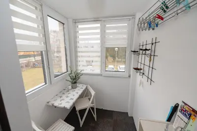 a small room with a table and two windows at Apartma Golob in Maribor