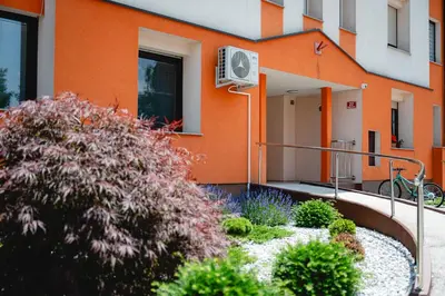 an orange building with a fan on the side of it at Apartma Golob in Maribor