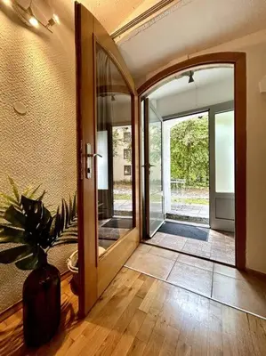 a hallway with an open door with a potted plant at Charming appartment 3-min walk to old town - FREE PARKING in Ljubljana