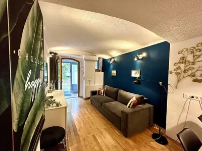 a living room with a couch and blue walls at Charming appartment 3-min walk to old town - FREE PARKING in Ljubljana