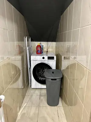 a laundry room with a washing machine and a trash can at Charming appartment 3-min walk to old town - FREE PARKING in Ljubljana